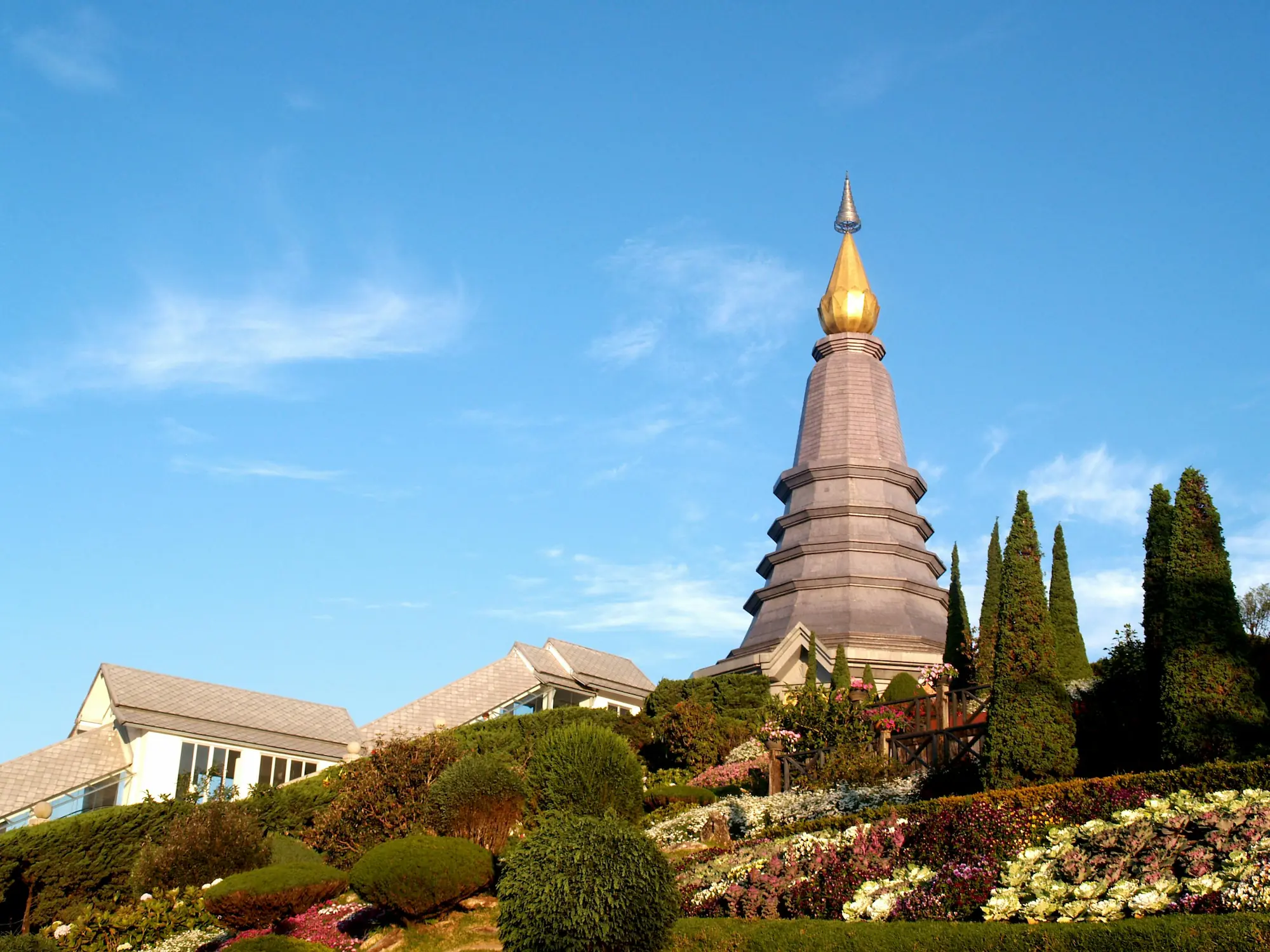 A temple or large structure at the top of a hill surrounded by gardens